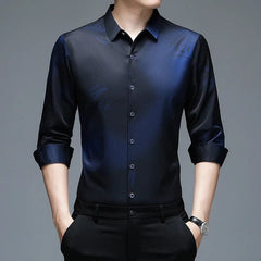 A man wears a long-sleeved, navy blue button-down shirt with a subtle print and turn-down collar.