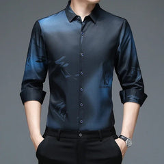A man wears a long-sleeved, navy blue button-down shirt with a subtle abstract print.