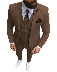 A man wears a slim-fit brown three-piece suit with a notch lapel, white shirt, and white sneakers.