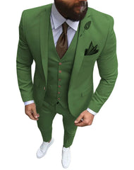 A man wears a slim-fit green three-piece suit with a white shirt, brown tie, and white sneakers.