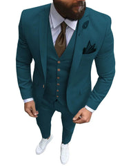 A man wears a teal three-piece slim-fit suit with a brown tie and white sneakers.