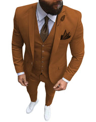 A man wears a slim-fit, three-piece brown suit with a white shirt, tie, and white sneakers.