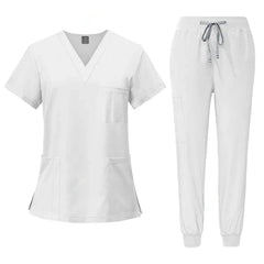 A white medical scrub set featuring a V-neck top with pockets and matching jogger-style pants.