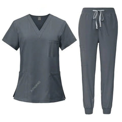 A dark gray women's scrub set featuring a V-neck top with pockets and matching jogger pants.