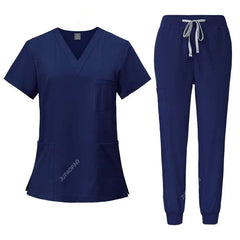 A navy blue women's scrub set featuring a V-neck top with pockets and matching jogger-style pants.