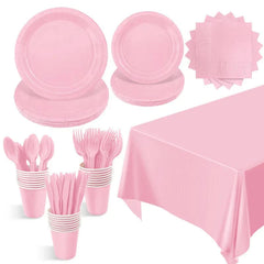 A light pink disposable party tableware set including plates, cups, napkins, cutlery, and a tablecloth.