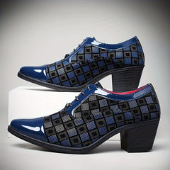 A pair of blue and black patterned lace-up dress shoes with a block heel.