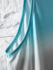 Close-up of the armhole and neckline of a blue and white ombre sleeveless tank top.