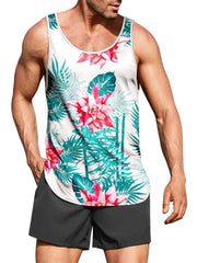A man wears a white tank top featuring a tropical palm leaf and pink flower print with black shorts.