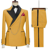 A yellow two-piece men's suit featuring a black lapel, bow tie, and decorative gold chain.