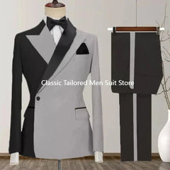 A two-piece men's suit featuring a color-blocked black and grey blazer with matching trousers.
