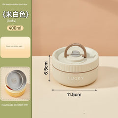 A beige, round, insulated lunch box with a handle and the word Lucky printed on the side.