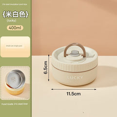 A beige, round, insulated lunch box with a handle and the word Lucky printed on the side.