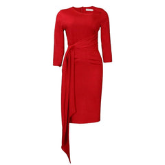 A red midi pencil dress with long sleeves, a slash neckline, and a draped waist tie detail.