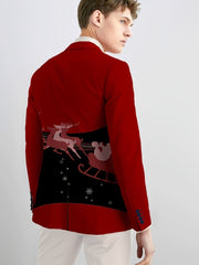 A man wears a red slim-fit blazer featuring a black panel on the back with a Santa sleigh print.