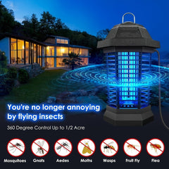 An outdoor electric bug zapper with a blue light, shown against a house at night.
