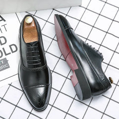 A pair of black leather brogue oxford shoes with red soles and lace-up closures.