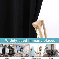 A black blackout curtain with grommets shown in a closet, clinic, fitting room, and office.