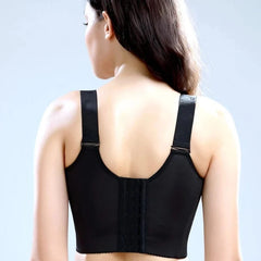 A woman seen from behind wearing a black wire-free bra with wide adjustable straps.