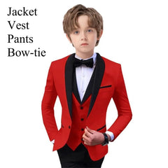 A boy wears a red tuxedo jacket with black lapels, a matching vest, and a black bow-tie.