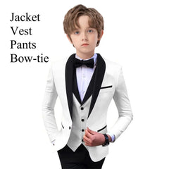A boy wears a white tuxedo jacket with black lapels, a matching vest, and a black bow tie.