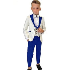 A boy wears a three-piece suit featuring a white paisley blazer with royal blue lapels, a matching vest, and royal blue trousers.