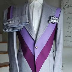 A grey two-piece men's suit featuring a symmetric purple and lavender chevron patchwork design.