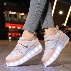 A pair of pink and white LED light-up roller skate sneakers with wheels on the soles.