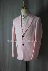 A light pink three-piece men's suit featuring a single-breasted jacket and matching vest.