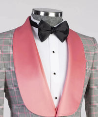 A grey plaid blazer with a wide pink satin shawl lapel worn with a white shirt and black bow tie.