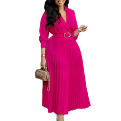 A long-sleeved, fuchsia midi dress with a V-neck, pleated skirt, and a matching waist belt.