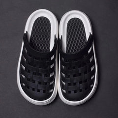Black closed-toe platform sandals with a woven-style upper and white soles.