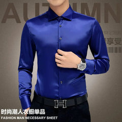 A man wears a long-sleeved, slim-fit royal blue button-down shirt with a classic collar.