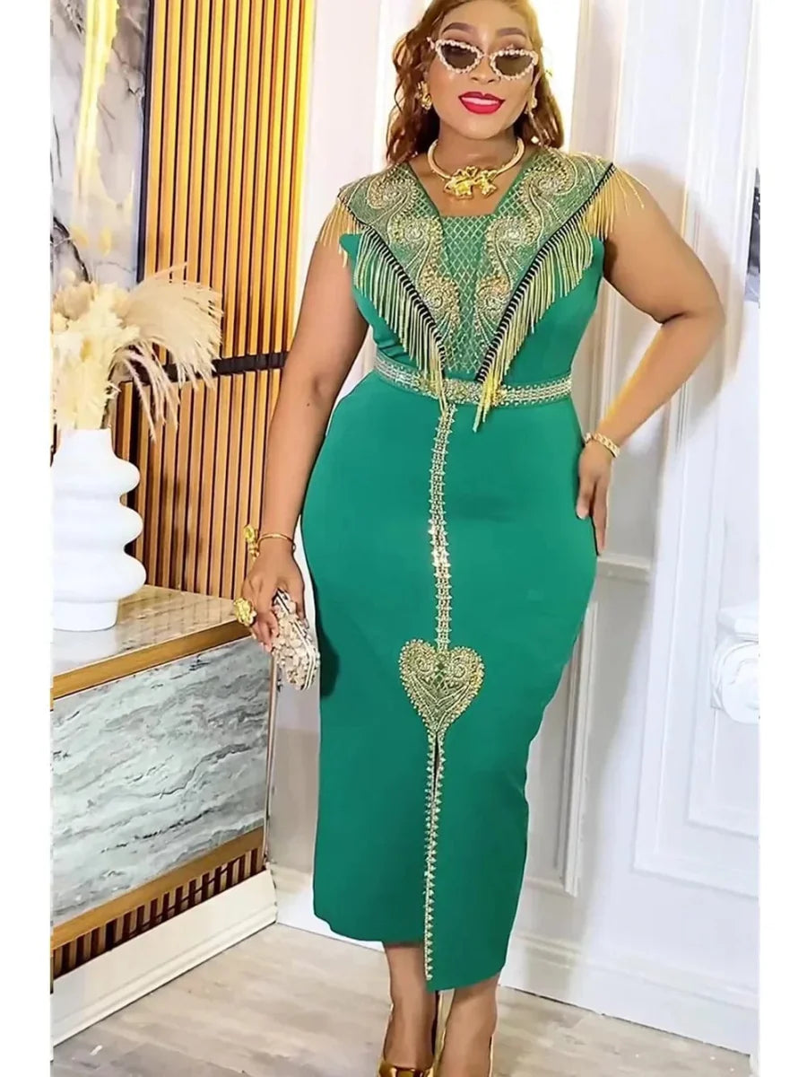 A woman wears a green midi-length dress with gold fringe, embroidery, and a heart-shaped detail.