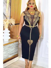A woman wears a black midi dress with gold fringe, intricate embroidery, and a heart-shaped detail.