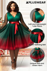 A plus size emerald green V-neck dress with sheer sleeves, a red waist belt, and a red gradient hem.