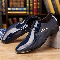 A pair of navy blue faux patent leather derby shoes with a textured pattern and gold accents.