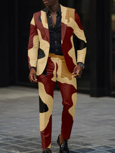 A man wears a slim fit two-piece suit featuring a digital camouflage print in tan, maroon, and black.