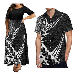 A woman wearing a black and white Polynesian print dress next to a man in a matching shirt.