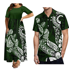 A woman wearing a green maxi dress and a man wearing a matching green button-down shirt.