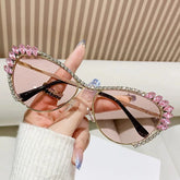 Cat eye sunglasses with pink gradient lenses and crystal-embellished gold metal frames.