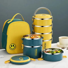 A yellow and teal insulated bento lunch box set with a matching smiley face carrying bag.