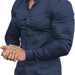 A man wears a navy blue muscle-fit long-sleeve button-down dress shirt.