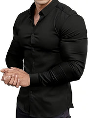 A man wears a black long-sleeve muscle-fit dress shirt with a button-down lapel.
