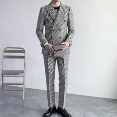 A man wears a slim-fit, double-breasted suit featuring an all-over black and white letter print.