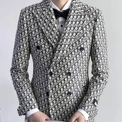 A man wears a slim-fit, double-breasted suit jacket featuring an all-over navy and white letter print.