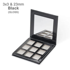 An empty black glossy eyeshadow palette with nine square compartments and an attached mirror.