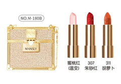 A gold glittery handbag containing three lipsticks in shades of peach, red, and orange.