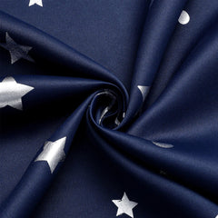 Navy blue blackout curtains featuring a silver star and moon print pattern.