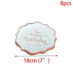 A stack of eight white paper plates with scalloped rose gold edges and Happy Birthday text.